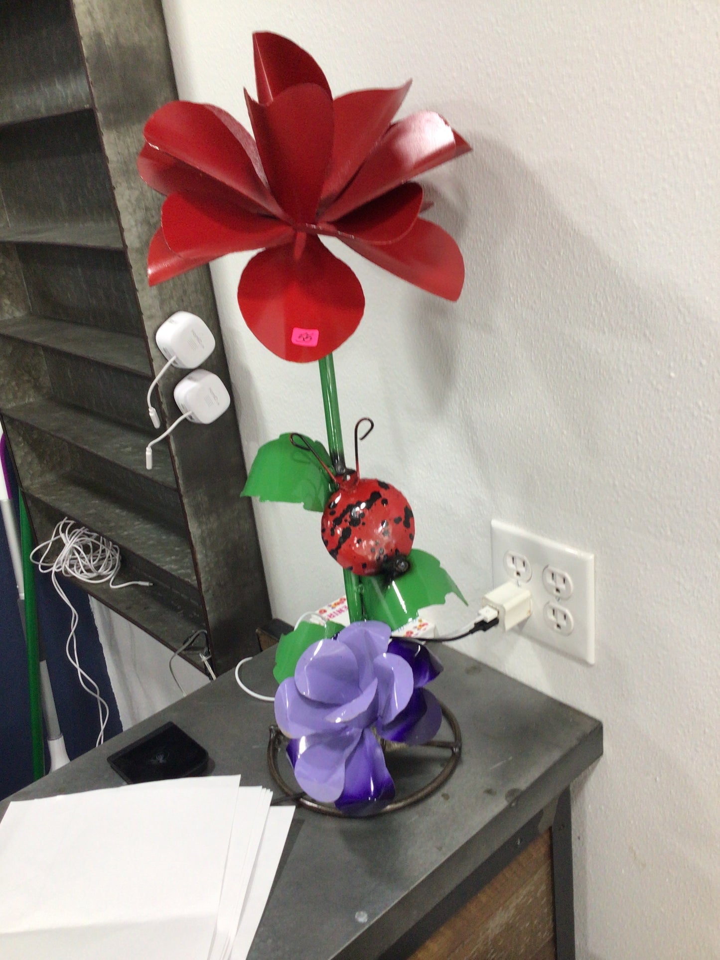 Red &purple flower w/ ladybug on rock